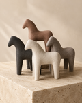 Abstract human figure sculpture set of 3 on marble surface - front view